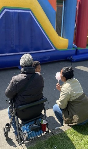 Buurtbewoners met een suikerspin bij het luchtkussen tijdens het straatfeest